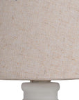Handcrafted beige Cyrene table lamp with oatmeal shade and white wooden base for warm, elegant lighting. by Sostter at brixbailey.com