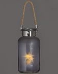 Frosted grey glass lantern with LED starlight glow, rope handle, and rustic modern design for indoor or outdoor ambiance by sostter at brixbailey.com