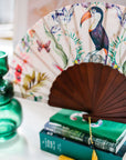 Floral Silk Fan with Toucan design and luxurious Gold tassel, part of the Mysa Collection