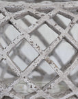 Round ceramic lattice hurricane lantern in natural stone, 17cm wide with intricate cutouts for ambient lighting. by Sostter at brixbailey.com