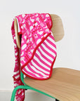 Premium organic baby blanket with pink garden print, soft 100% certified cotton, reversible design, stylish gift for newborns by Toby Tiger at brixbailey.com