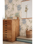 bold close-up of elegant blue floral wallpaper with intricate artisan-made patterns for a nursery