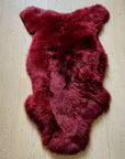 Premium British sheepskin rug, luxury Bordeaux red fleece throw, large ethically sourced organic sheepskin, soft hypoallergenic sustainable fur by Wildash London at brixbailey.com