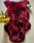 Premium British sheepskin rug, luxury Bordeaux red fleece throw, large ethically sourced organic sheepskin, soft hypoallergenic sustainable fur by Wildash London at brixbailey.com
