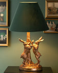 Antique gold marching hare lamp with green velvet shade, handcrafted resin sculpture, warm ambient lighting by RoomLondon at brixbailey.com