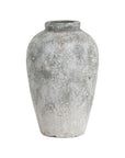 bold statement tall ceramic vase with dramatic aged stone texture in a modern living room