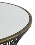 Handcrafted brass side table with black patina finish, mirrored glass top, and concave silhouette for modern interiors. by Sostter at brixbailey.com