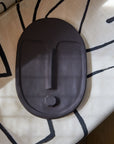 bold abstract ceramic wall mask in anthracite grey with a striking matte terracotta glaze