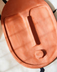 bold handcrafted terracotta wall mask with a striking matte orange glaze