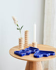 elegant blue ceramic wave tray with speckled glaze, resting on a marble surface in soft natural light
