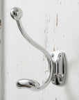 Minimalist chrome coat hanger with reflective silver finish for wall mounting, modern home organization by Sostter at brixbailey.com