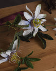 White artificial passion flower spray with verdant foliage, lifelike petals and corona filaments, 89cm home decor accent by sostter at brixbailey.com