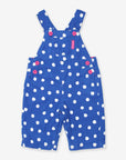 Premium organic cotton polka dot pinafore overalls, soft blue with white dots, stylish pink buttons, cozy jersey lining, adjustable straps by Toby Tiger at brixbailey.com