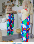 Premium Toby Tiger kids denim overall with multicolor heart print, adjustable straps, soft organic cotton, stylish blue pinafore for toddlers by Toby Tiger at brixbailey.com