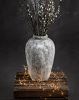 elegant tall ceramic vase with a refined aged stone texture in soft morning light
