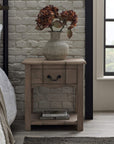 Handcrafted French provincial side table with hardwood construction, bleached wood finish, and black iron handles. by Sostter at brixbailey.com
