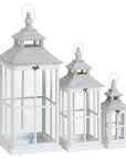 White wooden lantern with intricate window detailing, casting light patterns for coastal or Scandinavian decor. by RoomLondon at brixbailey.com
