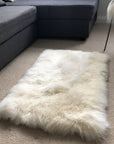 Premium British sheepskin rug, luxury white fur throw, soft plush ivory cream, handcrafted rectangular 55cm x 85cm, best-selling home decor by Wildash London at brixbailey.com