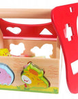 bold wooden farmhouse shape sorter with vibrant animal blocks in a bright, focused close-up