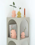 playful pink ceramic fluxo vase on a sunlit windowsill, casting a soft shadow