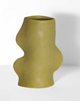 softly lit pistachio ceramic vase casting a gentle shadow on a cozy shelf