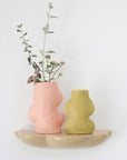 bold pistachio ceramic vase with dramatic lighting highlighting its flowing handmade form