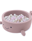 bold raspberry pink whale ball pit with plush boucle texture in a bright nursery