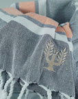 Luxury Hampton hammam towel, premium soft cotton, dark navy with orange and white stripe, handloomed in Turkey, quick-drying, absorbent, stylish yacht and sailboat accessory by Wildash London at brixbailey.com