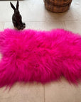 Luxury hot pink sheepskin rug, premium Icelandic sheepskin throw, large 100-110cm, soft long fur, stylish home decor, best-selling statement piece by Wildash London at brixbailey.com