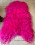 Luxury hot pink sheepskin rug, large Icelandic throw, premium natural fur, 100-110cm, stylish home decor, best-selling vibrant statement piece by Wildash London at brixbailey.com