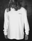 Oversized white long sleeve with handprinted WWOOLLFF CO. graphics, premium organic cotton, stylish unisex design by WWOOLLFF CO. at brixbailey.com