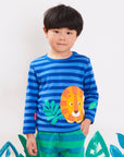 Luxury Organic Cotton Long Sleeve Baby Shirt with Lion Design and Snap Buttons in Blue and Orange Stripes by Toby Tiger at brixbailey.com