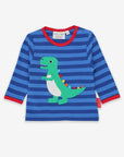 Premium baby T-rex striped organic cotton shirt with soft spiked applique, blue and red contrast trim, snap neck closure by Toby Tiger at brixbailey.com