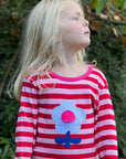 Vibrant Flower Power Pink Striped Organic Cotton Long Sleeve Shirt with Retro Floral Applique and Interactive Ladybug Flap by Toby Tiger at brixbailey.com