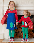 Premium dark blue Christmas dress with penguin applique, long sleeves, red-white polka dot yoke, GOTS certified organic cotton by Toby Tiger at brixbailey.com