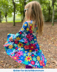 Premium organic cotton floral print skater dress for girls, stylish dark blue Toby Tiger design with snowdrops daisies tulips, long sleeves, eco-friendly by Toby Tiger at brixbailey.com