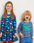 Organic Rainbow Dinosaur Skater Dress for Kids, Soft GOTS-Certified Cotton with Long Sleeves, Eco-Friendly Play Outfit by Toby Tiger at brixbailey.com