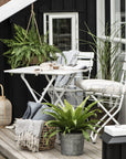 Modern white metal bistro table and chairs set, stylish folding patio furniture for balcony or garden, compact and space-saving by Ella James at brixbailey.com