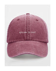 a soft cotton cap with the riesling to exist slogan in warm, gentle light