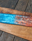 Walnut striking blue and bronze river board