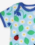 Premium baby summer romper with ladybug print in soft sky blue, certified organic cotton, short legs, snap buttons, breathable by Toby Tiger at brixbailey.com