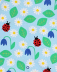 Premium baby summer romper with ladybug print in soft blue, certified organic cotton, short legs, snap buttons, breathable by Toby Tiger at brixbailey.com