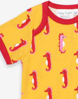 Luxury baby romper with short legs, playful seahorse design, red trim, snap buttons, organic cotton, sustainable fashion by Toby Tiger at brixbailey.com