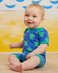 Premium baby summer romper with short legs, cute turtle print, snap buttons, soft organic cotton, easy slip-on neckline by Toby Tiger at brixbailey.com