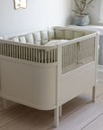 Premium organic cotton kapok bumper in mist green, soft hypoallergenic breathable filling for baby beds, fits standard 60x120cm cribs by Ella James at brixbailey.com