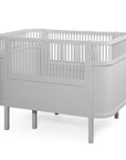 Premium Sebra baby and junior cot bed in stylish stone grey, luxury handcrafted beech wood with adjustable mattress, best-selling Nordic design by Ella James at brixbailey.com