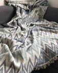 Luxury Sirocco organic cotton jacquard weave throw, oversized 200x250cm, soft muted green blue grey zigzag pattern, premium bedspread or sofa blanket by Wildash London at brixbailey.com