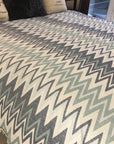 Luxury Sirocco organic cotton jacquard weave throw, oversized 200x250cm, soft muted zigzag pattern, elegant trim, premium bedspread or sofa blanket by Wildash London at brixbailey.com