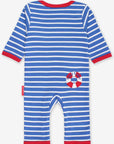 Dream of the next seaside vacation with our magical organic cotton pajamas for kids, featuring sailboat and lighthouse appliques, blue-white stripes, and red accents for a nautical vibe, with slip-on neck and snap buttons for comfort by Toby Tiger at brixbailey.com