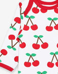Premium organic cotton pajamas with cherry print, stylish red accents, slip-on neckline, snap buttons, soft GOTS-certified fabric by Toby Tiger at brixbailey.com